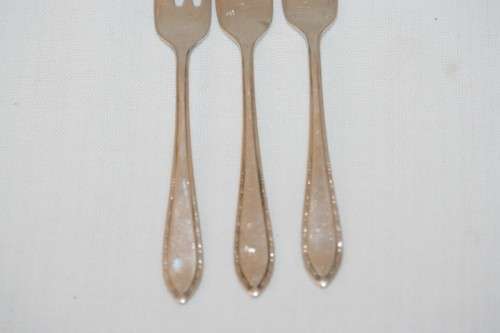 A fantastic set of three antique hallmarked Arthur Price & Co. sterling silver cake forks