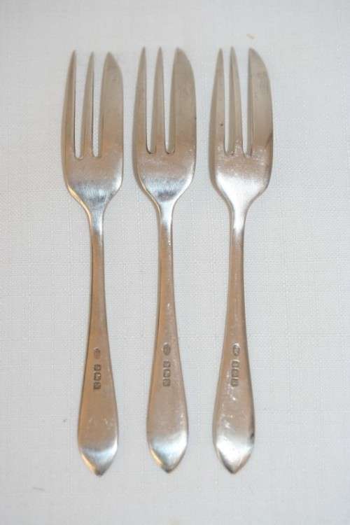 A fantastic set of three antique hallmarked Arthur Price & Co. sterling silver cake forks