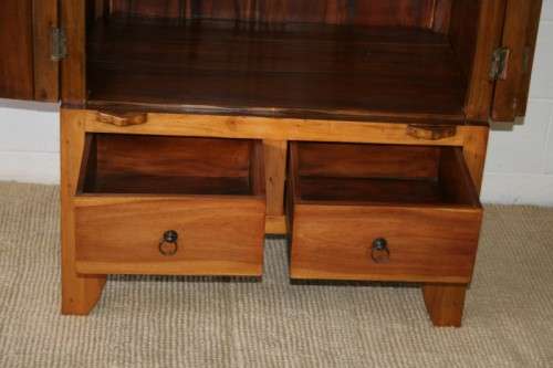 A magnificent Indonesian teak entertainment cabinet with traditional solid brass embellishments