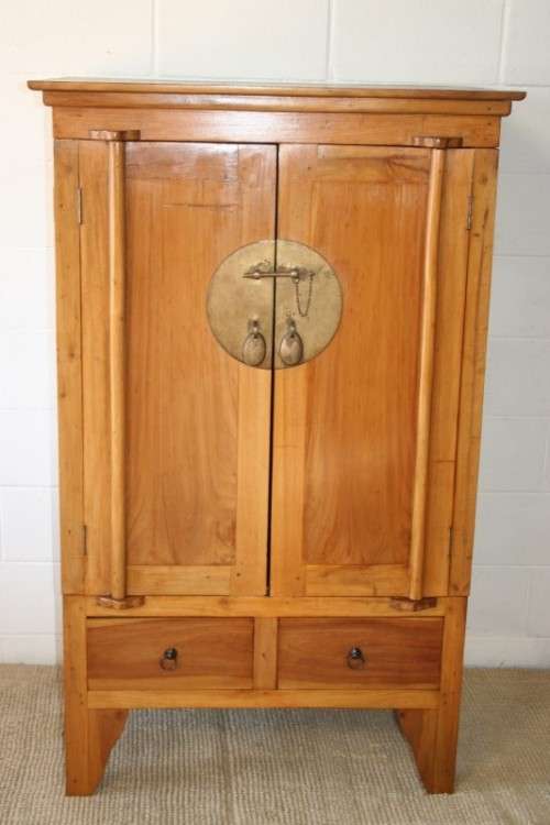 A magnificent Indonesian teak entertainment cabinet with traditional solid brass embellishments