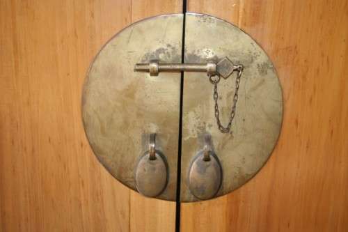 A magnificent Indonesian teak entertainment cabinet with traditional solid brass embellishments
