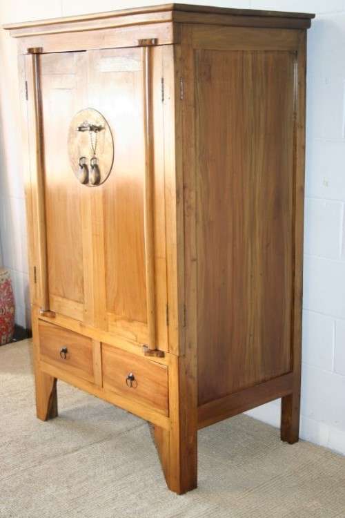 A magnificent Indonesian teak entertainment cabinet with traditional solid brass embellishments