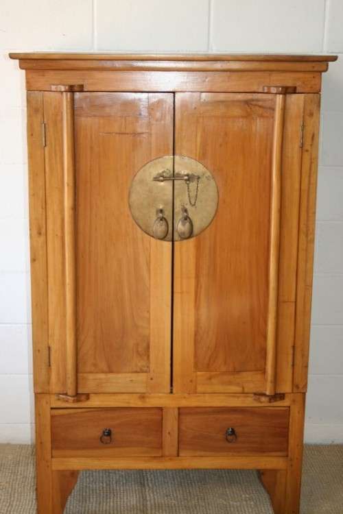 A magnificent Indonesian teak entertainment cabinet with traditional solid brass embellishments