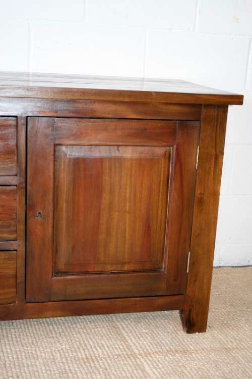 An exquisite solid oriental teak three-drawer cabinet w/ a good size cupboard in wonderful condition
