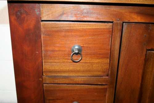 An exquisite solid oriental teak three-drawer cabinet w/ a good size cupboard in wonderful condition