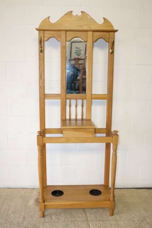 A stunning tall oak hall stand with a beveled mirror, storage box and 2 hooks in great condition.
