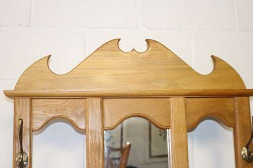 A stunning tall oak hall stand with a beveled mirror, storage box and 2 hooks in great condition.