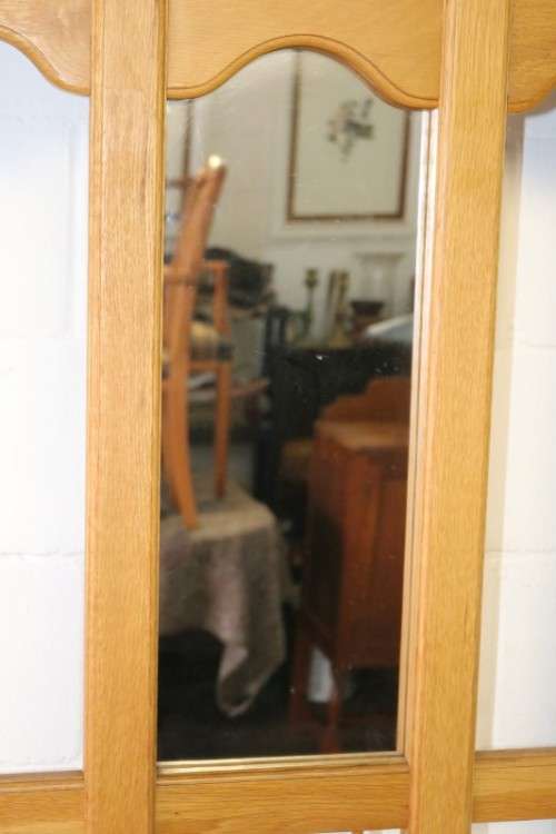 A stunning tall oak hall stand with a beveled mirror, storage box and 2 hooks in great condition.