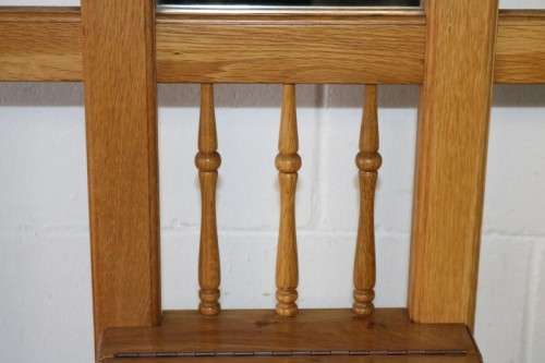 A stunning tall oak hall stand with a beveled mirror, storage box and 2 hooks in great condition.