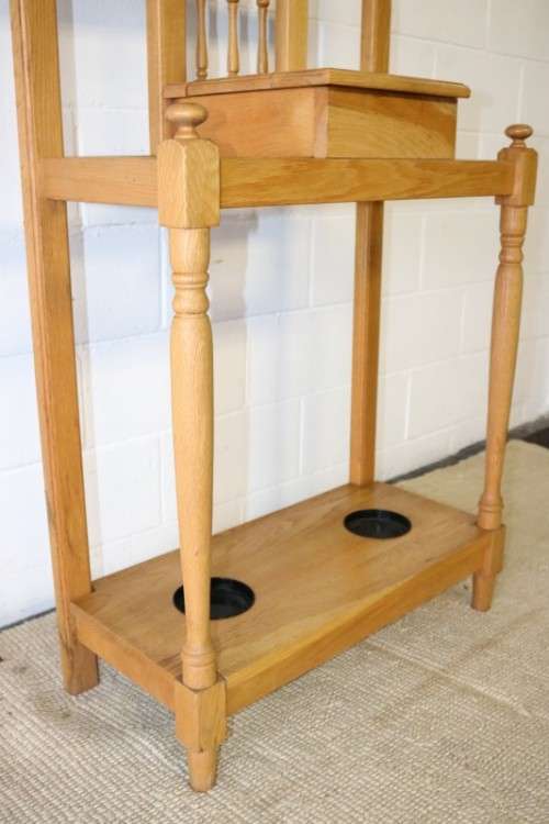 A stunning tall oak hall stand with a beveled mirror, storage box and 2 hooks in great condition.