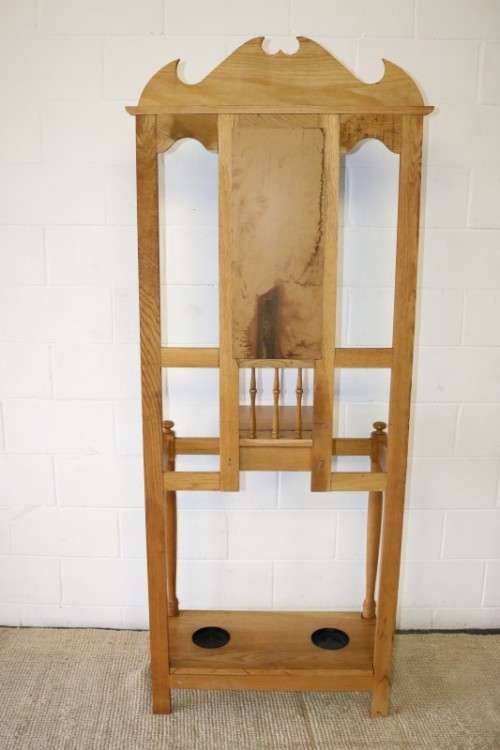 A stunning tall oak hall stand with a beveled mirror, storage box and 2 hooks in great condition.