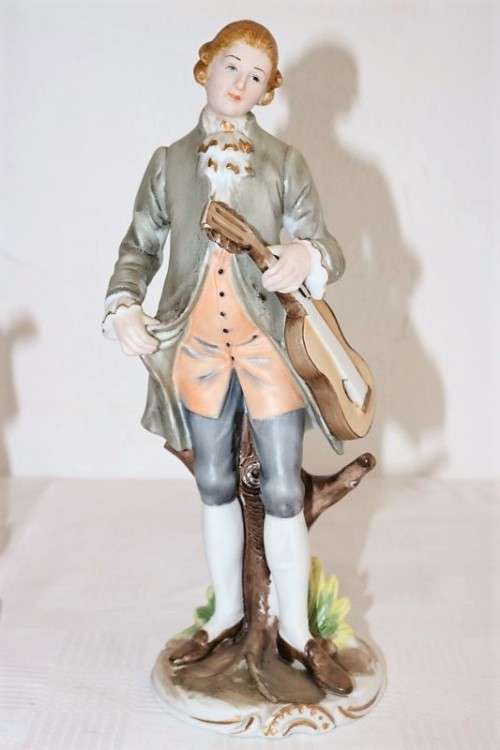 Three wonderful ceramic figurines of men with musical instruments with hand painted detailing