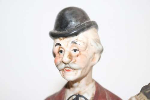 Three wonderful ceramic figurines of men with musical instruments with hand painted detailing