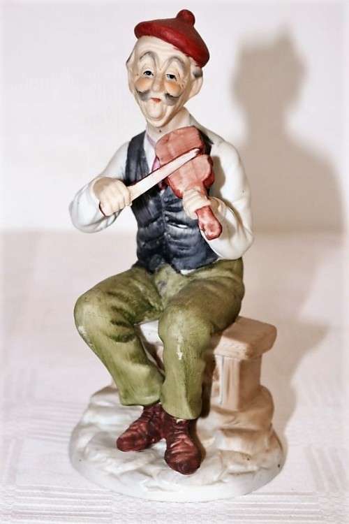 Three wonderful ceramic figurines of men with musical instruments with hand painted detailing