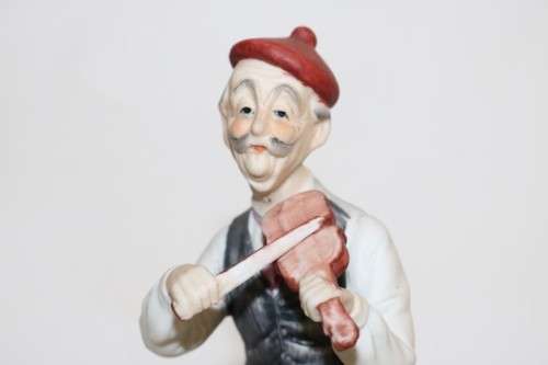 Three wonderful ceramic figurines of men with musical instruments with hand painted detailing