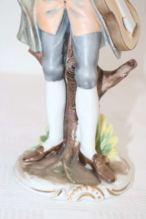 Three wonderful ceramic figurines of men with musical instruments with hand painted detailing