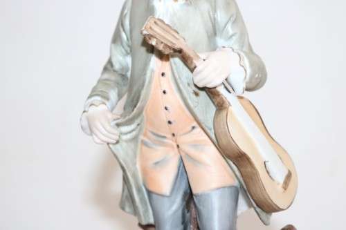 Three wonderful ceramic figurines of men with musical instruments with hand painted detailing
