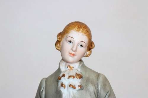 Three wonderful ceramic figurines of men with musical instruments with hand painted detailing