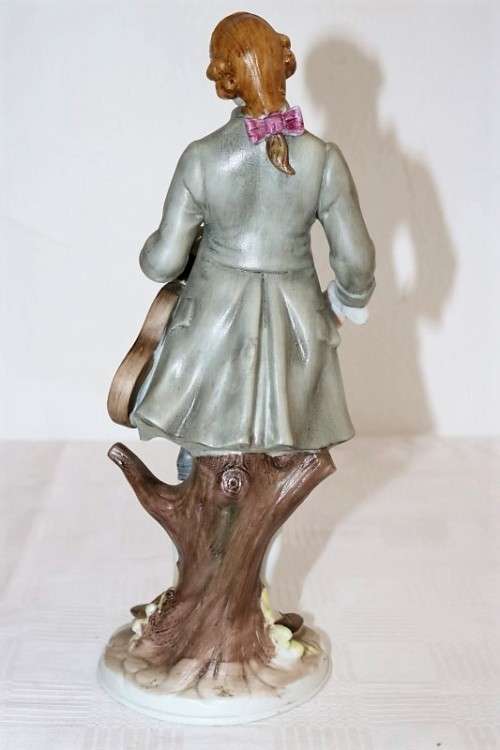 Three wonderful ceramic figurines of men with musical instruments with hand painted detailing