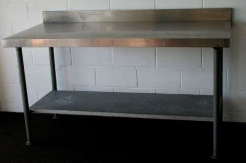 A fantastic (1.68m) stainless steel catering table with splash-back and galvanised storage shelf