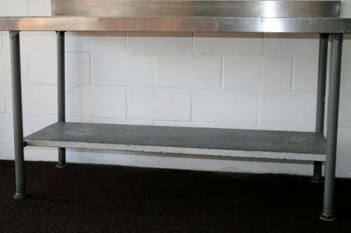 A fantastic (1.68m) stainless steel catering table with splash-back and galvanised storage shelf