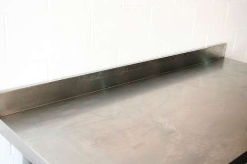 A fantastic (1.68m) stainless steel catering table with splash-back and galvanised storage shelf