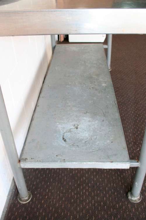 A fantastic (1.68m) stainless steel catering table with splash-back and galvanised storage shelf