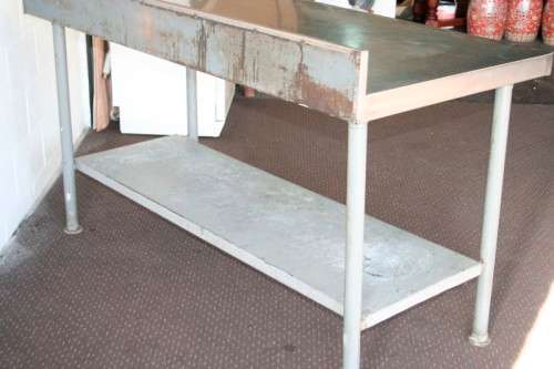 A fantastic (1.68m) stainless steel catering table with splash-back and galvanised storage shelf