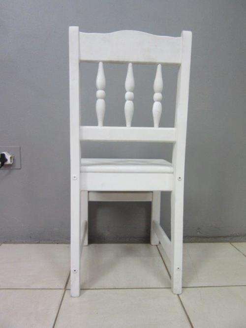 A solid wooden white dining in good condition - perfect for a beach house!