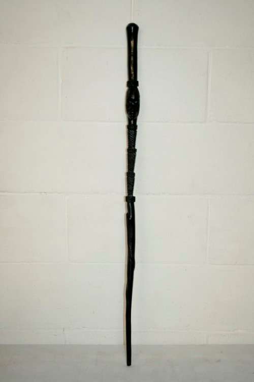 An incredibly detailed collectable hand carved African black wood walking stick - 91cm