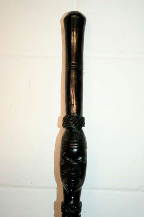 An incredibly detailed collectable hand carved African black wood walking stick - 91cm