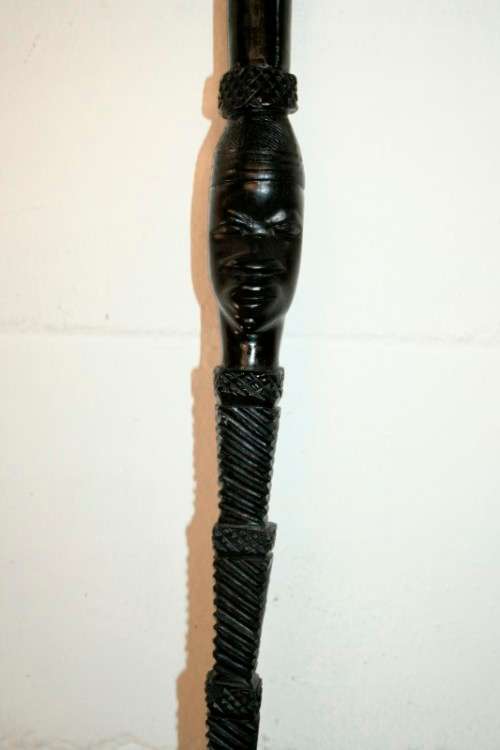 An incredibly detailed collectable hand carved African black wood walking stick - 91cm