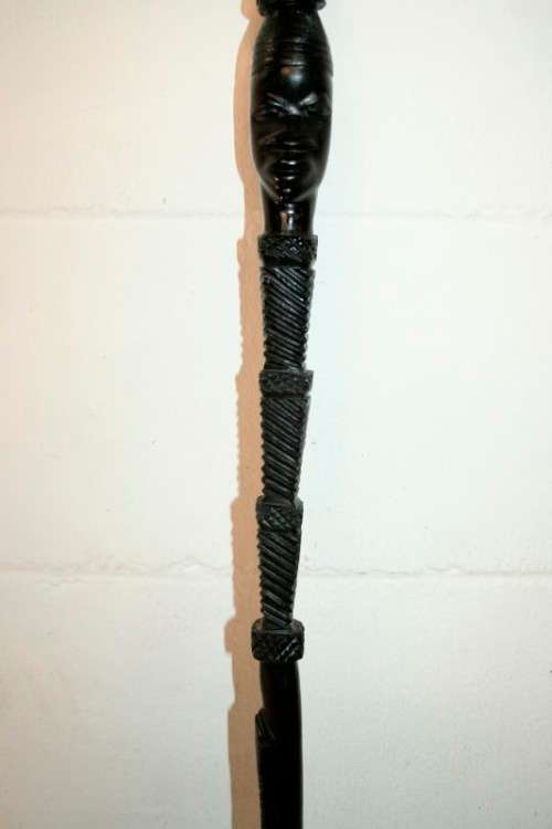 An incredibly detailed collectable hand carved African black wood walking stick - 91cm