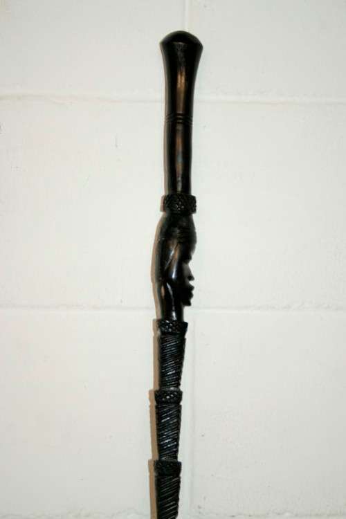 An incredibly detailed collectable hand carved African black wood walking stick - 91cm