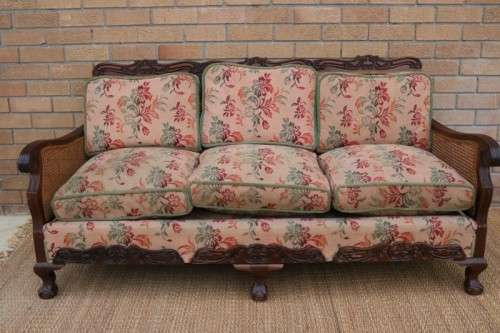 A wonderful antique hand carved ball and claw three-seater wicker-back sofa w/ upholstered cushions