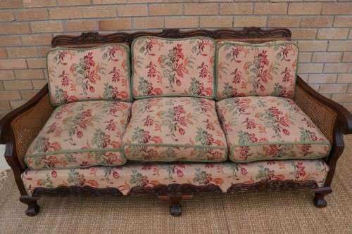 A wonderful antique hand carved ball and claw three-seater wicker-back sofa w/ upholstered cushions
