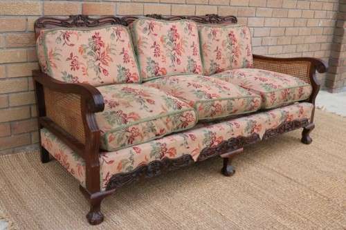 A wonderful antique hand carved ball and claw three-seater wicker-back sofa w/ upholstered cushions