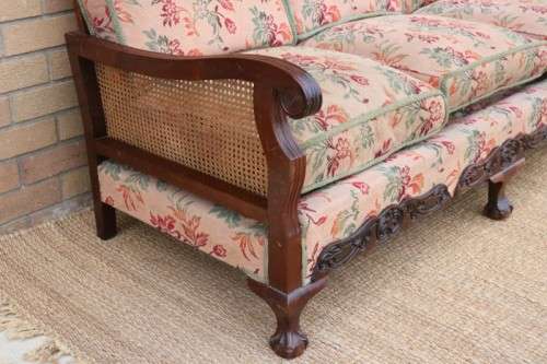 A wonderful antique hand carved ball and claw three-seater wicker-back sofa w/ upholstered cushions