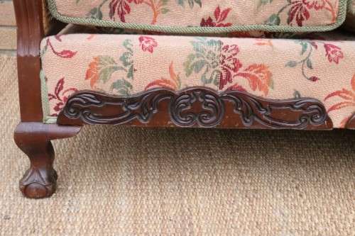 A wonderful antique hand carved ball and claw three-seater wicker-back sofa w/ upholstered cushions