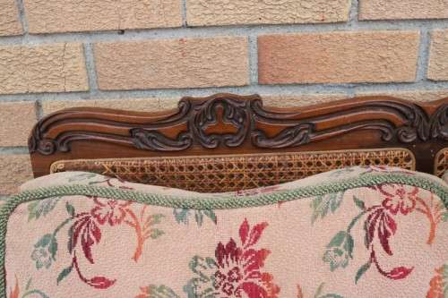 A wonderful antique hand carved ball and claw three-seater wicker-back sofa w/ upholstered cushions