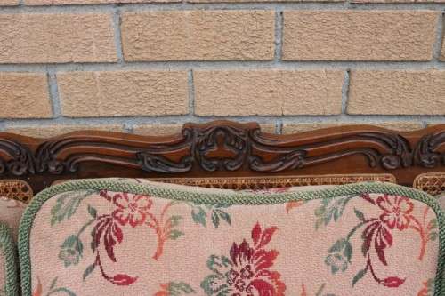 A wonderful antique hand carved ball and claw three-seater wicker-back sofa w/ upholstered cushions