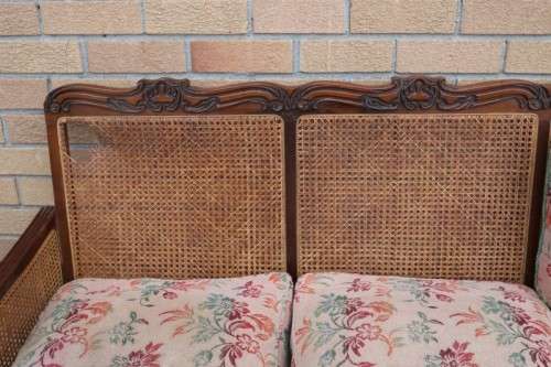 A wonderful antique hand carved ball and claw three-seater wicker-back sofa w/ upholstered cushions