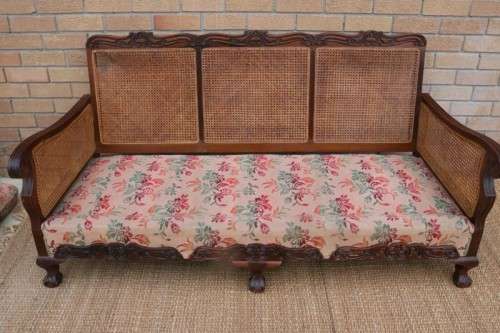 A wonderful antique hand carved ball and claw three-seater wicker-back sofa w/ upholstered cushions