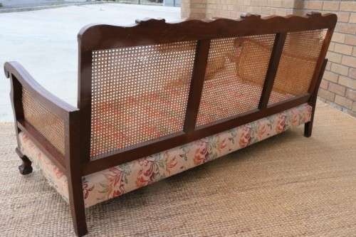 A wonderful antique hand carved ball and claw three-seater wicker-back sofa w/ upholstered cushions