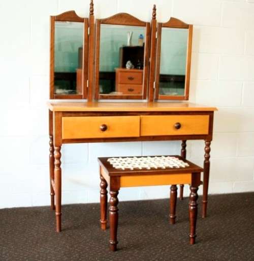 An exquisite two-drawer yellow wood & imbuia side-folding mirror dressing table with a riempie stool