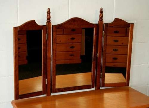 An exquisite two-drawer yellow wood & imbuia side-folding mirror dressing table with a riempie stool