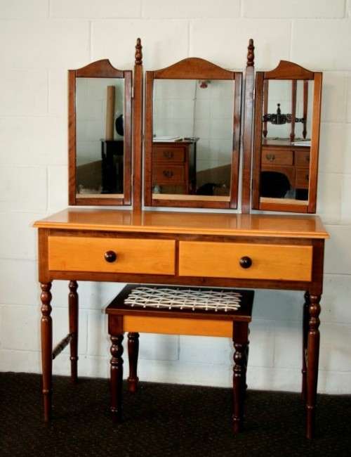 An exquisite two-drawer yellow wood & imbuia side-folding mirror dressing table with a riempie stool