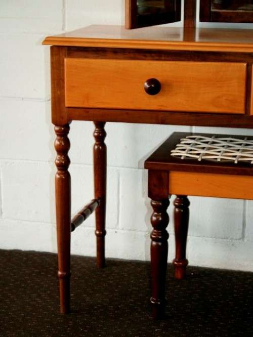 An exquisite two-drawer yellow wood & imbuia side-folding mirror dressing table with a riempie stool