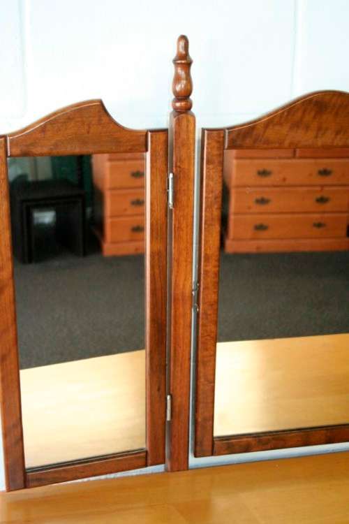 An exquisite two-drawer yellow wood & imbuia side-folding mirror dressing table with a riempie stool