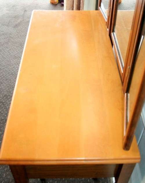 An exquisite two-drawer yellow wood & imbuia side-folding mirror dressing table with a riempie stool